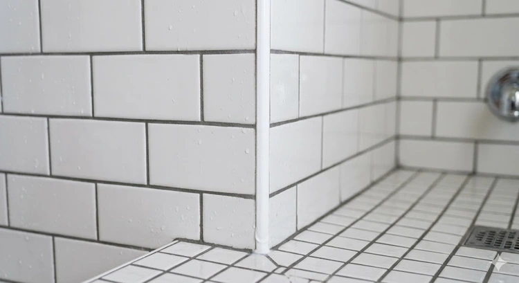grout vs caulk application zones in a bathroom tile installation