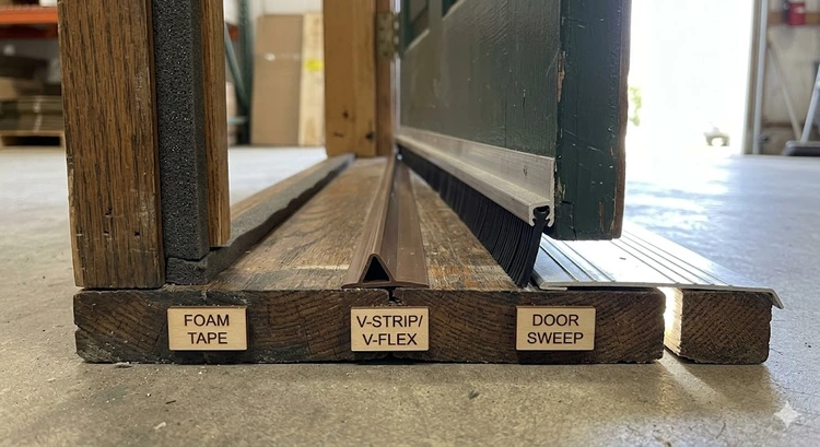 how to choose weatherstripping for exterior doors — foam tape, V-strip, door sweep, and bulb seal laid out on workbench